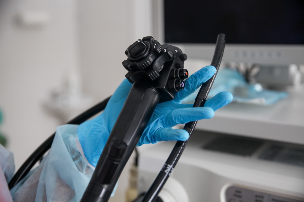 an-endoscopist-in-blue-gloves-holds-an-endoscope-in-his-hands.jpg